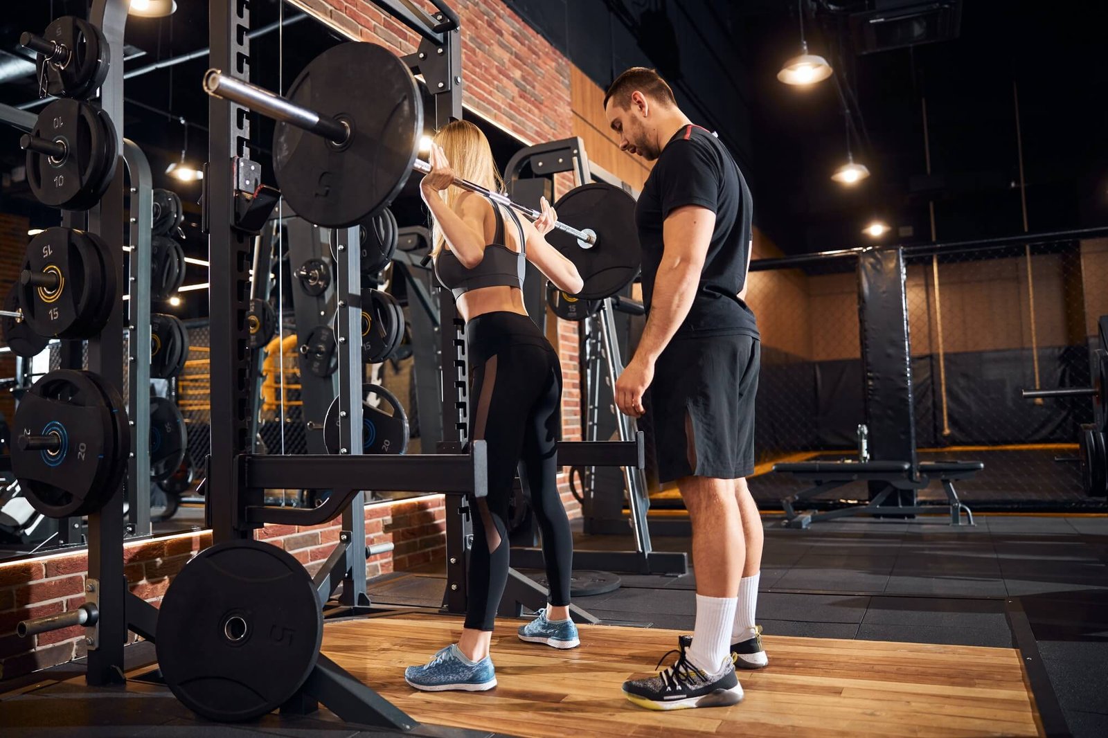 professional-gym-instructor-assisting-woman-at-the-gym-1.jpg